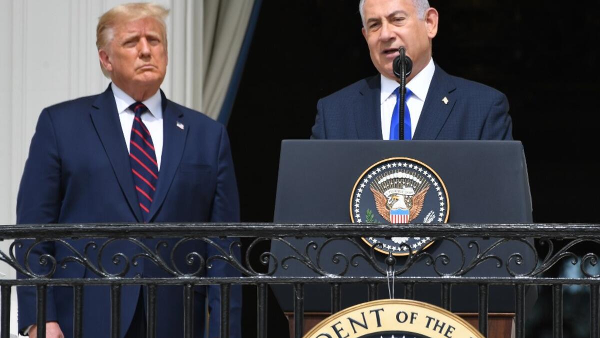 US President Donald Trump watches as Israeli Prime Minister Benjamin Netanyahu (R) speaks from the Truman Balcony at the White House during the signing ceremony of the Abraham Accords where the countries of Bahrain and the United Arab Emirates recognize Israel, on the South Lawn of the White House in Washington, DC, September 15, 2020.