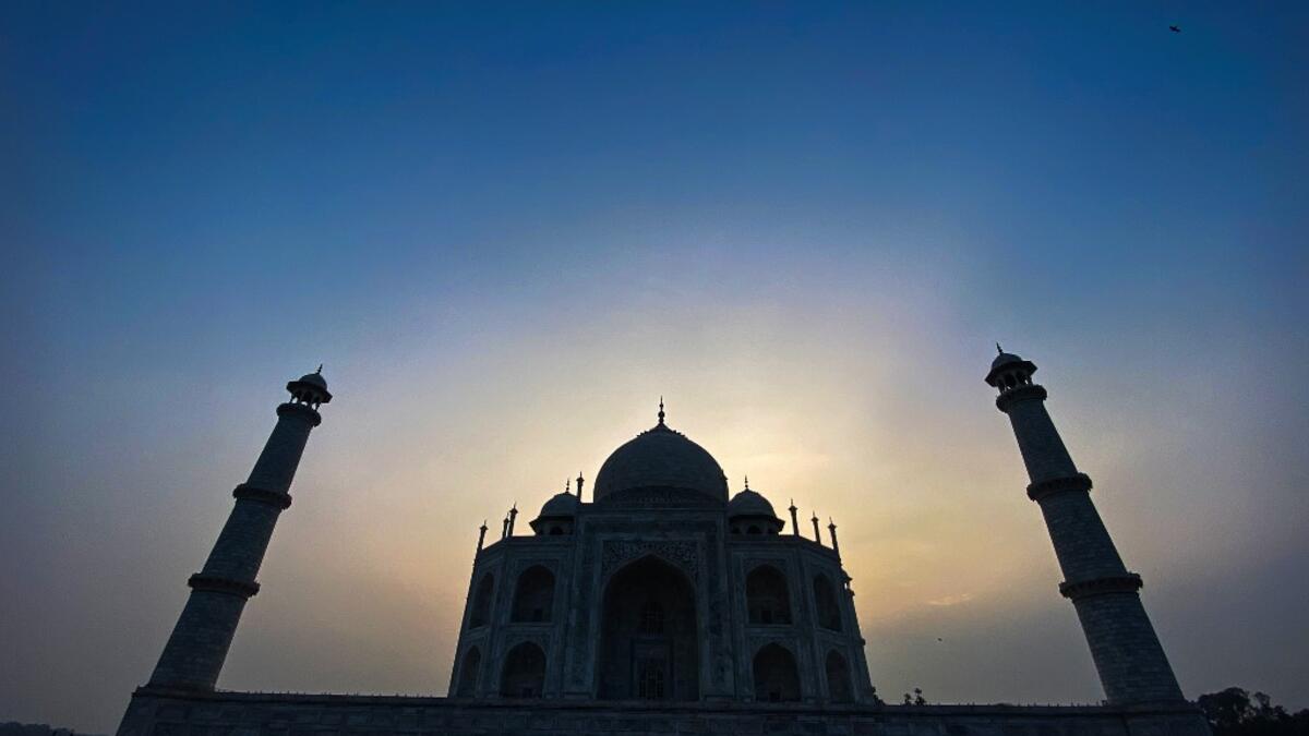 The sun rises behind the Taj Mahal in Agra on September 21, 2020. The Taj Mahal reopened to visitors on September 21 in a symbolic business-as-usual gesture even as India looks set to overtake the US as the global leader in coronavirus infections. Sajjad HUSSAIN / AFP