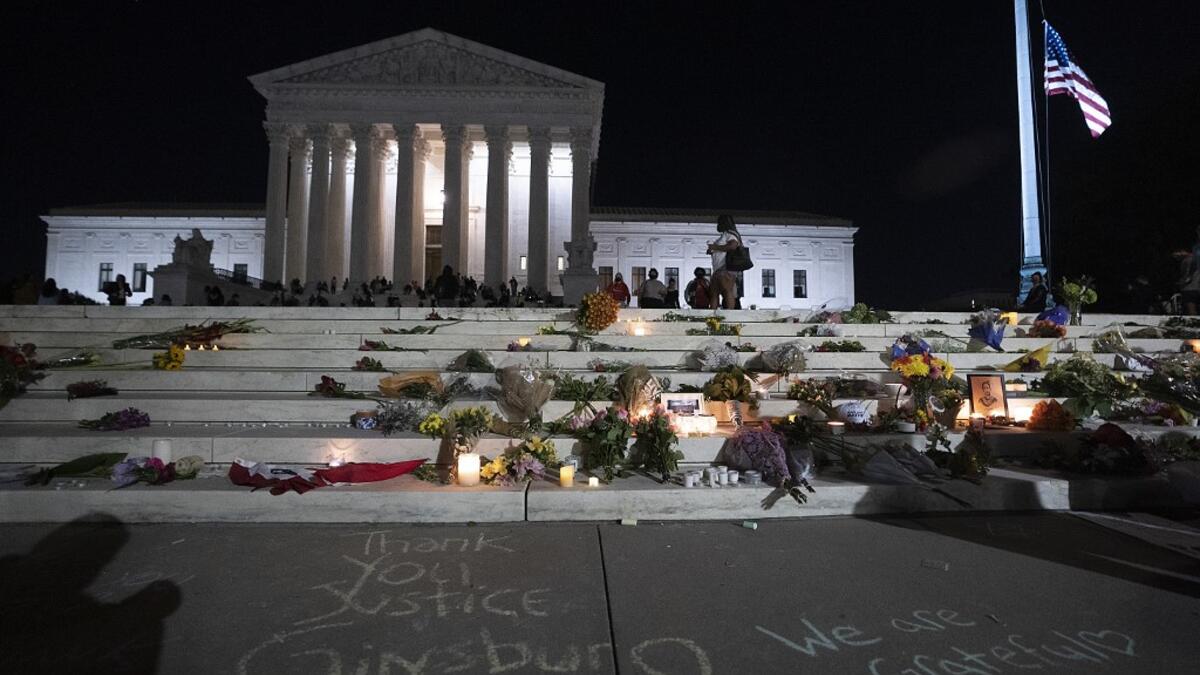 The national flag flies at half staff as people gather to mourn the passing of Supreme Court Justice Ruth Bader Ginsburg at the steps in front of the Supreme Court on September 18, 2020 in Washington, DC. Ginsburg has died at age 87 after a battle with pancreatic cancer. Tasos Katopodis/Getty Images/AFP TASOS KATOPODIS / GETTY IMAGES NORTH AMERICA / Getty Images via AFP