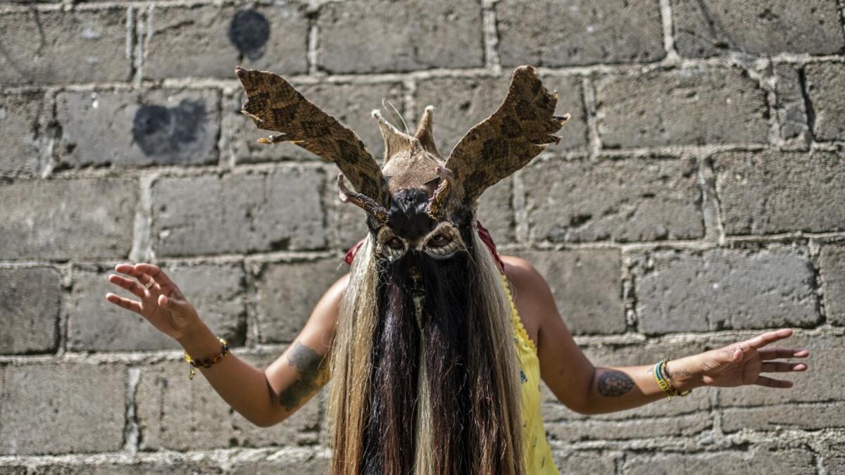 Mijane Jimenez, 31, activist of the Afro-Mexican community, wears a "Diablo" mask in Cuajinicuilapa, Guerrero state, Mexico, on September 10, 2020, amid the COVID-19 coronavirus pandemic. Although there are 1,5 million African descendants in a country of 128 million inhabitants, it is normal to hear that "in Mexico there are no blacks". PEDRO PARDO / AFP