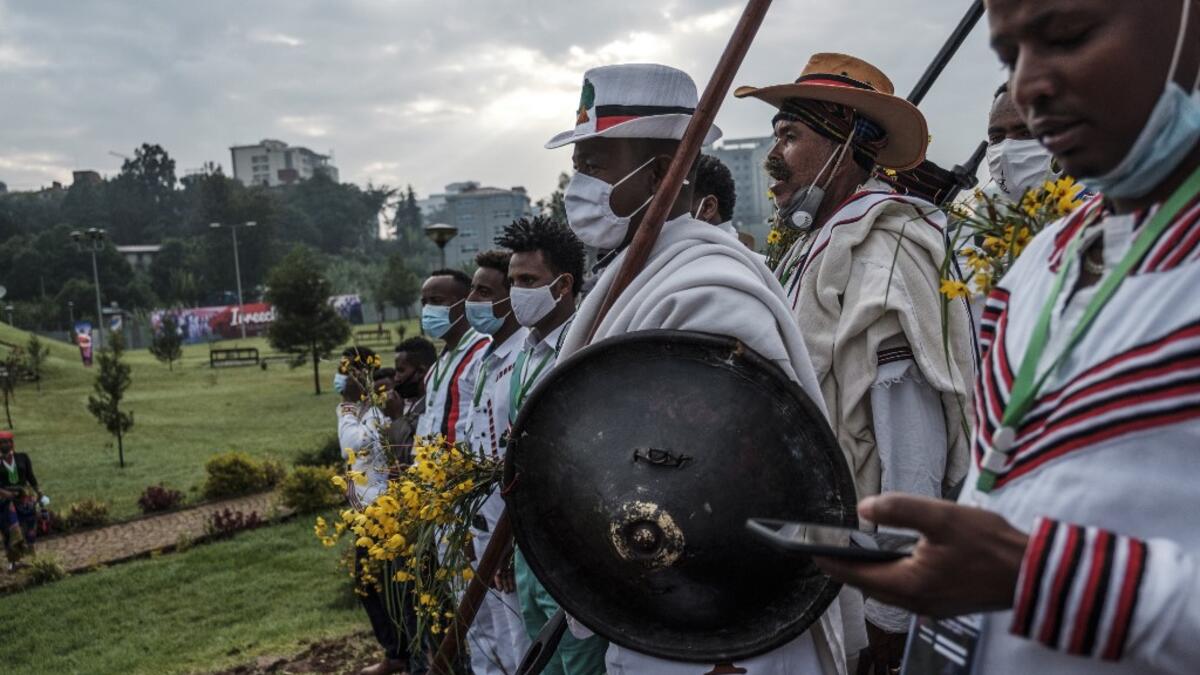 People in traditional clothing march during the celebration of “Irreechaa”, the Oromo people thanksgiving holiday, in Addis Ababa, Ethiopia, on October 3, 2020. Members of Ethiopia's largest ethnic group gathered under heavy security in Addis Ababa for a scaled-back version of their annual thanksgiving festival against a backdrop of unrest and political division. EDUARDO SOTERAS / AFP