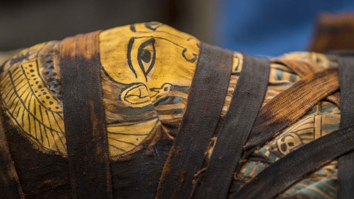 A picture taken on October 3, 2020 shows a mummy, excavated by the Egyptian archaeological mission which resulted in the discovery of a deep burial well with more than 59 human coffins closed for more than 2,500 years, displayed during a press conference at the Saqqara necropolis, 30 kms south of the Egyptian capital Cairo. They were unearthed south of Cairo in the sprawling burial ground of Saqqara, the necropolis of the ancient Egyptian capital of Memphis, a UNESCO World Heritage site. Their exteriors are