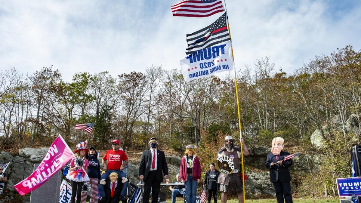 People dressed in political costumes participate in a contest during a Trump campaign rally named "Trumptoberfest" at Rocky Point Park in Warwick, Rhode Island on October 11, 2020. Many supporters dressed in political campaign clothing and waved flags while others dressed in festive costumes to take part in a political costume contest. Joseph Prezioso / AFP