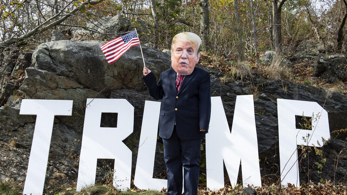 A contestant dressed as President Trump participates in a Trump campaign rally named "Trumptoberfest" at Rocky Point Park in Warwick, Rhode Island on October 11, 2020. Many supporters dressed in political campaign clothing and waved flags while others dressed in festive costumes to take part in a political costume contest. Joseph Prezioso / AFP