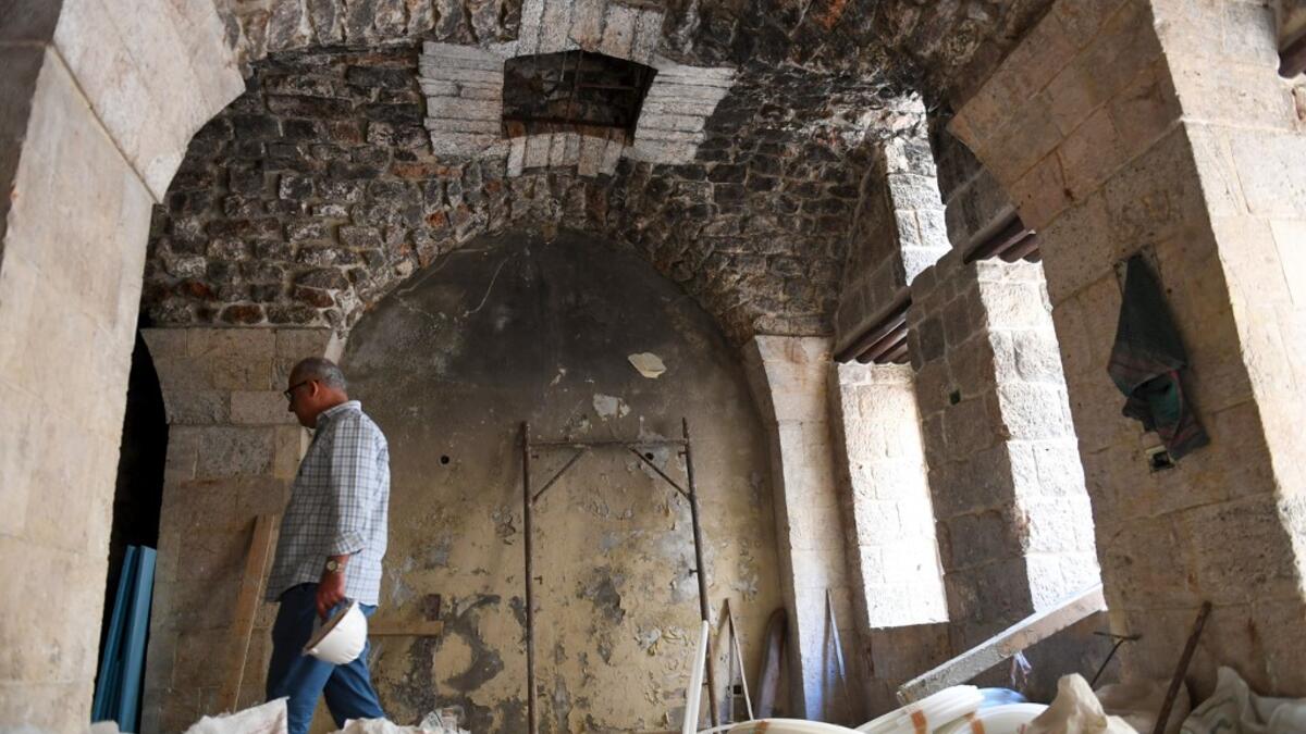 Syrian workers take part in the reconstruction of Martini restaurant and hotel in the Jdaideh neighbourhood in Aleppo's Old City on October 17, 2020. AFP