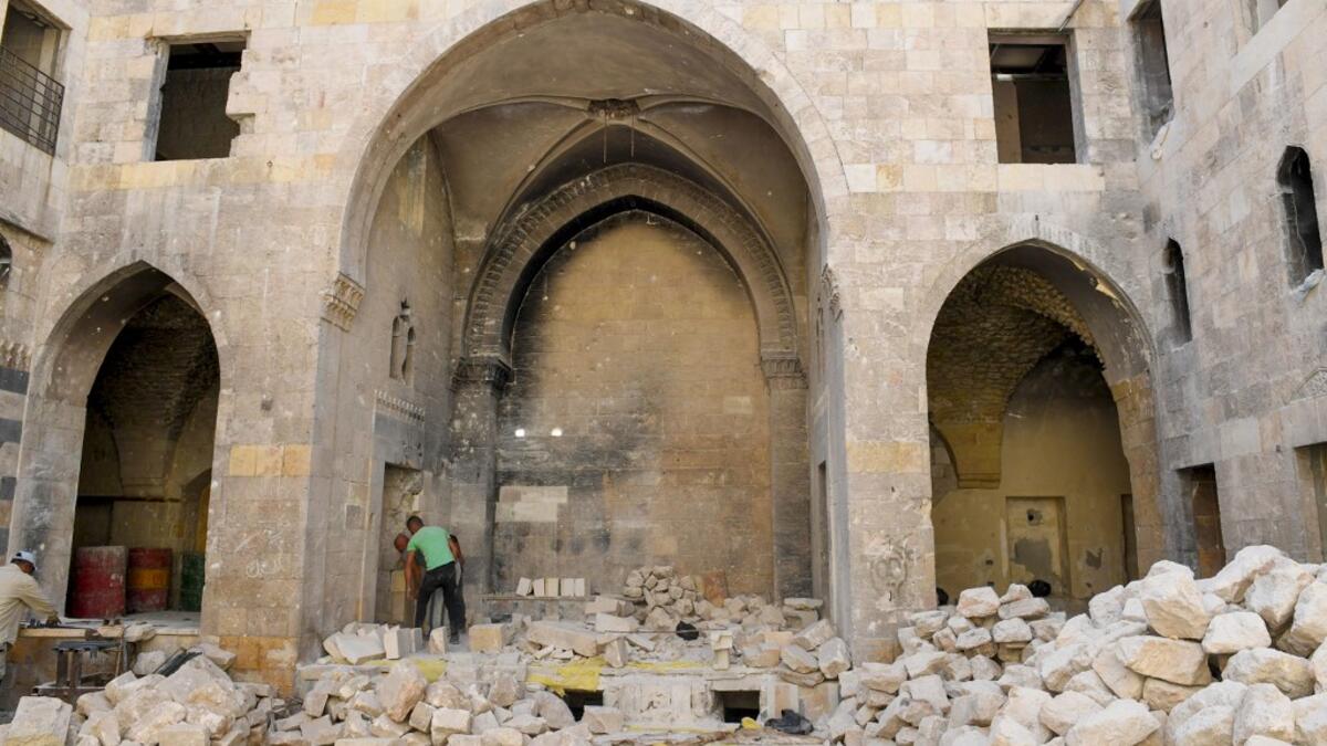 Syrian workers take part in the reconstruction of Martini restaurant and hotel in the Jdaideh neighbourhood in Aleppo's Old City on October 17, 2020. AFP