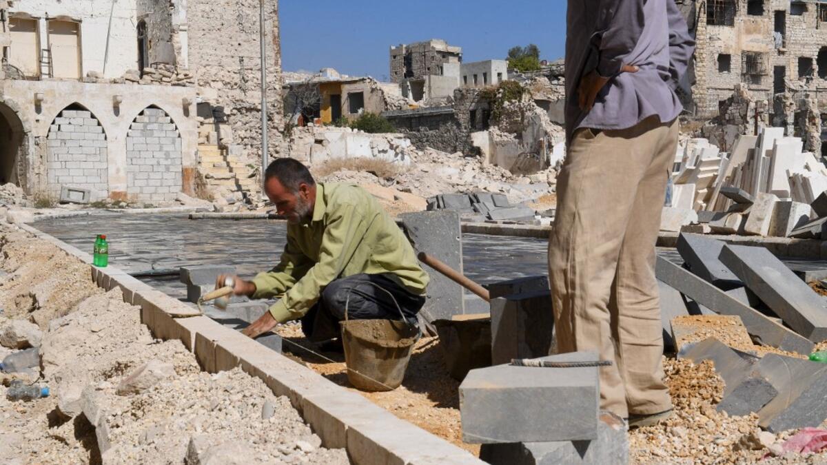 Syrian workers take part in the reconstruction of the Hatab Square in the Jdaideh neighbourhood in Aleppo's Old City on October 17, 2020. AFP