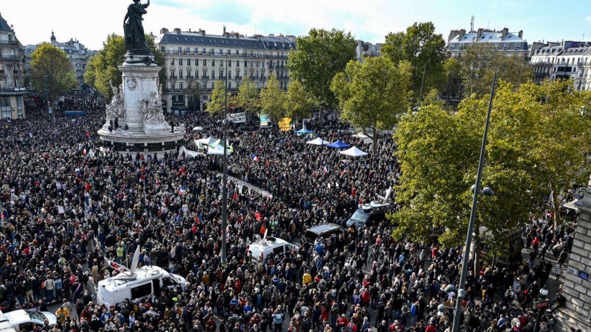 People gather on Place de la Republique in Paris on October 18, 2020, in homage to history teacher Samuel Paty two days after he was beheaded by an attacker who was shot dead by policemen. BERTRAND GUAY / AFP
