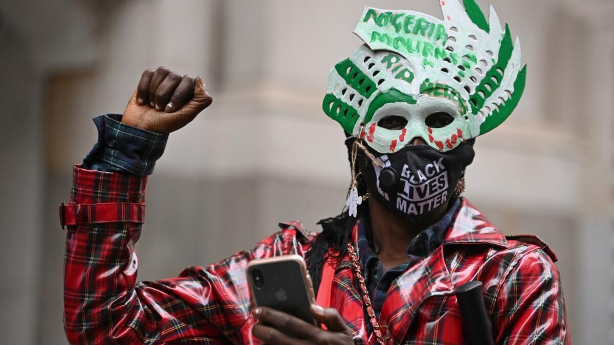 Protestors attend a demonstration outside the Nigerian High Commission against police brutality in Lagos in London on October 21, 2020. UN Secretary General Antonio Guterres called Wednesday for an end to what he called "brutality" by police in Nigeria, which has been rocked by two weeks of protests. Guterres said gunmen that opened fire on peaceful protesters Tuesday evening in Lagos caused "multiple deaths" and many injuries. DANIEL LEAL-OLIVAS / AFP