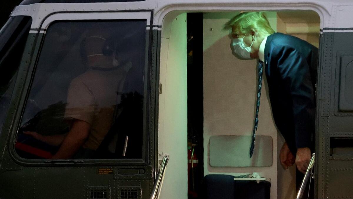 U.S. President Donald Trump talks to Marine One helicopter pilots while returning to the White House from Walter Reed National Military Medical Center on October 05, 2020 in Washington, DC. Trump spent three days hospitalized for coronavirus. Win McNamee/Getty Images/AFP WIN MCNAMEE / GETTY IMAGES NORTH AMERICA / Getty Images via AFP