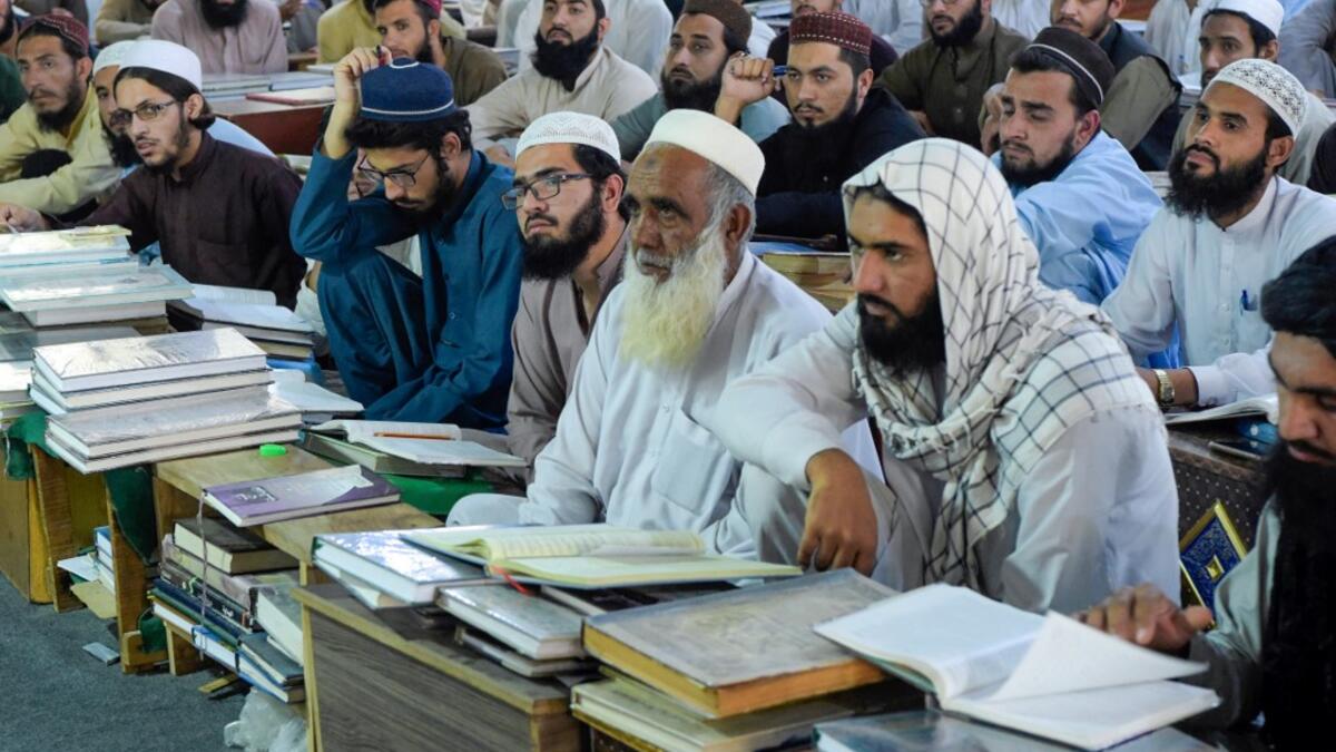 In this picture taken on October 19, 2020 Islamic seminary students gather in the premises of the hostel at the Darul Uloom Haqqania seminary in Akora Khattak which has churned out a who's who of Taliban top brass -- including many now on the hardline group's negotiating team holding talks with the Kabul government to end a 20-year war. Abdul MAJEED / AFP