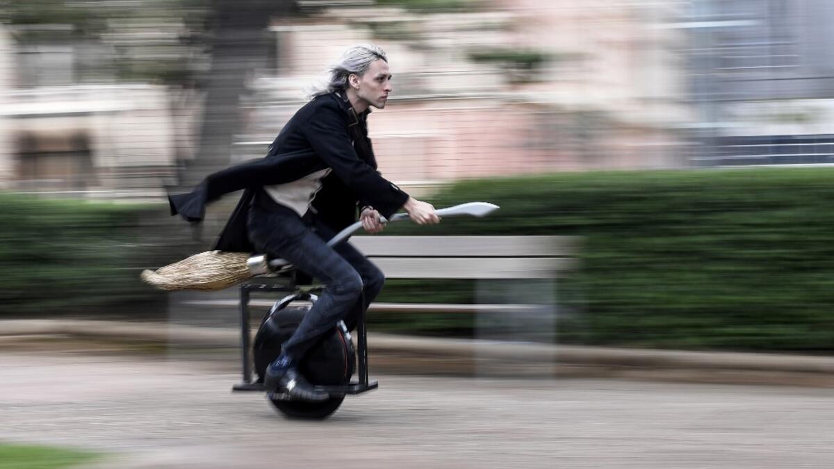 Alessandro Russo rides his "flying broom" on Halloween at Praca da Liberdade square, at Belo Horizonte, Brazil, on October 31, 2020. Russo developed a broom inspired by Harry Potter and the model is coupled to an electric unicycle and it is possible to run it at a speed of up to 60 km/h. DOUGLAS MAGNO / AFP