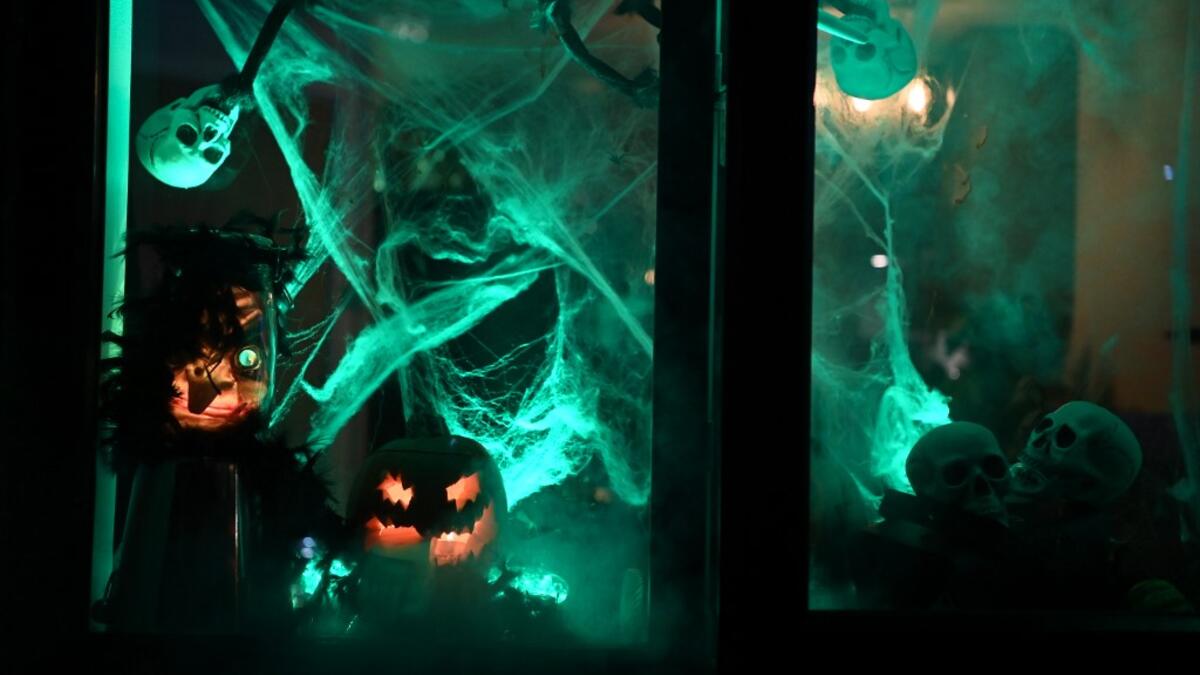 The window of a home is decorated for Halloween in east London on October 31, 2020. DANIEL LEAL-OLIVAS / AFP