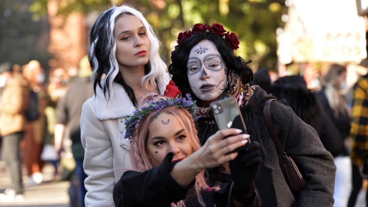 Costumed revelers take a selfi on Halloween in Salem, Massachusetts on October 31, 2020. Salem canceled all official Halloween events and called for the city wide shutdown of all businesses at 20h00EDT (24H00GMT) in an effort to control the spread of Covid-19 and detour tourist from visiting Salem, a favorite of Halloween fans. Joseph Prezioso / AFP