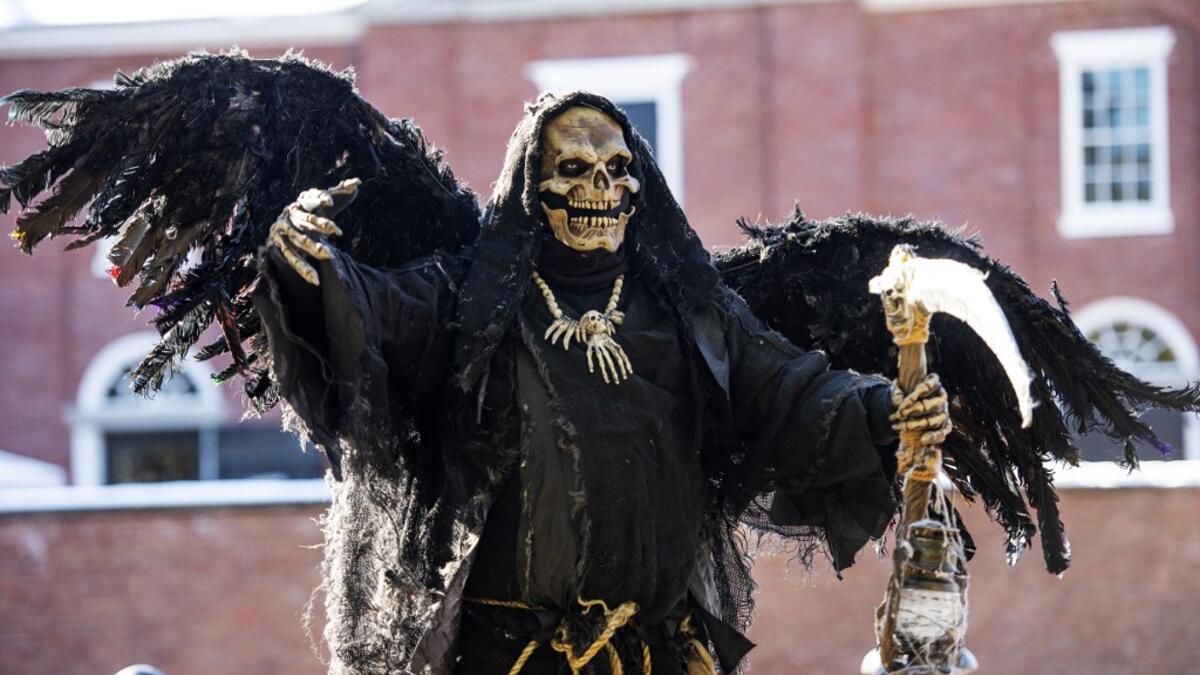Costumed revelers walk the city streets on Halloween in Salem, Massachusetts, on October 31, 2020. Salem canceled all official Halloween events and called for the city wide shutdown of all businesses at 20h00EDT (24H00GMT) in an effort to control the spread of Covid-19 and detour tourist from visiting Salem, a favorite of Halloween fans. Joseph Prezioso / AFP
