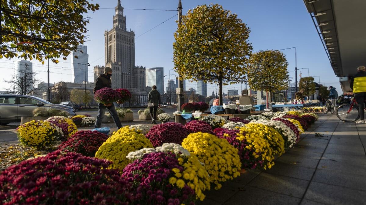 Flower vendors sell Chrysanthemums in the center of Warsaw, Poland on November 1, 2020, while the polish government closed cemeteries due to COVID-19 restrictions two days before the All Saints' Day, preventing Poles from visiting their loved ones graves according to tradition. The Polish government announced on October 30, 2020 the closure of cemeteries for three days, around All Saints' Day, to curb the outbreak of new contaminations in the country. Wojtek RADWANSKI / AFP