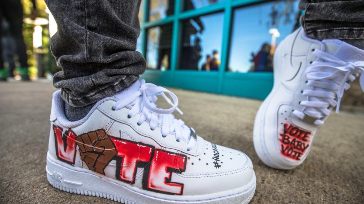Grammy nominated artist "DaBaby" shows his shoes as he promotes his voter support efforts, "Vote Baby Vote", by hosting an event at a polling location in Charlote, North Carolina, November 3, 2020. The United States started voting Tuesday in an election amounting to a referendum on Donald Trump's uniquely brash and bruising presidency, which Democratic opponent and frontrunner Joe Biden urged Americans to end to restore "our democracy."  Grant Baldwin / AFP