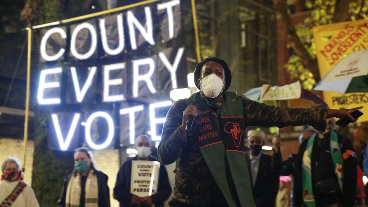 Reverend Bianca Davis-Lovelace of the Washington State Poor People's Campaign speaks at a rally and march to "Count Every Vote, Protect Every Person" a day after the US Presidential Election in Seattle, Washington on November 4, 2020. Democratic presidential challenger Joe Biden on November 4 neared the magic number of 270 electoral votes needed to win the White House with several battleground states still in play, as incumbent President Donald Trump challenged the vote count. Jason Redmond / AFP