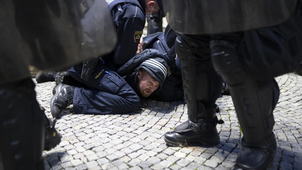 Police officers hold down a protestor as they clash with police during the rally against government’s coronavirus restrictions in Ljubljana on November 5, 2020. Jure Makovec / AFP