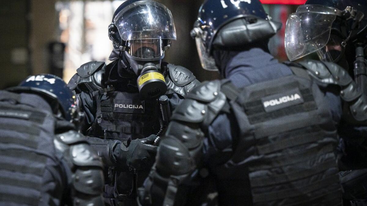 Police officers wear gas masks and anti-riot gear after firing tear gas against protesters as they clash with police during the rally against government’s coronavirus restrictions in Ljubljana on November 5, 2020. Jure Makovec / AFP