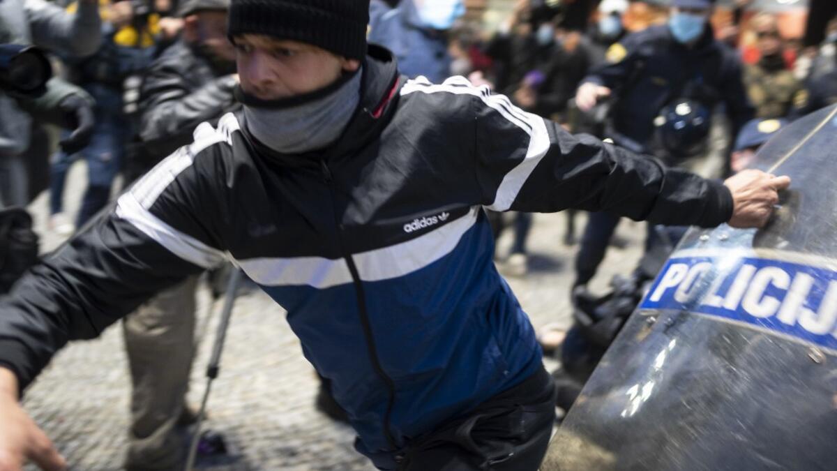 A protestor clashes with police officers during the rally against government’s coronavirus restrictions in Ljubljana on November 5, 2020. Jure Makovec / AFP