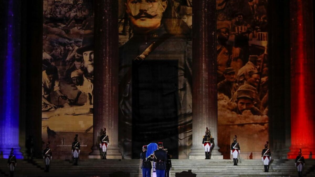 Soldiers carry the coffin of Late French writer Maurice Genevoix before being laid to rest in the crypt of the Pantheon mausoleum during a national tribute for Genevoix and 'Men of 14' as part of Armistice Day commemorations marking the end of World War I, on November 11, 2020, in Paris, as part of the commemorations marking the 102nd anniversary of the November 11, 1918 Armistice, ending World War I (WWI). AFP