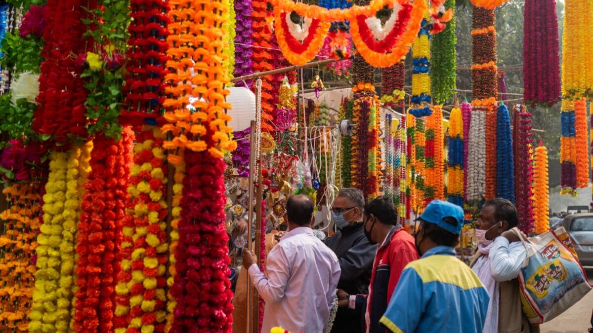 People buy decorations for Diwali, the Hindu Festival of Lights, from a stall in a market area in New Delhi on November 14, 2020. Jewel SAMAD / AFP