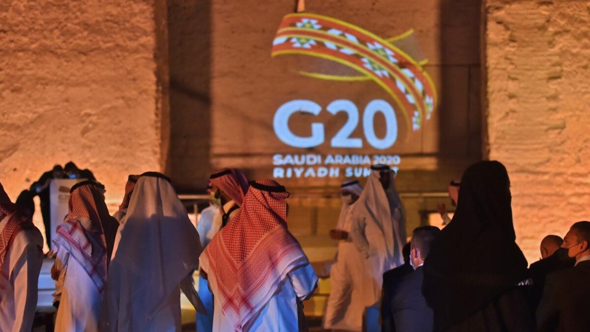 The G20 logo is projected at the historical site of al-Tarif in Diriyah district, on the outskirts of Saudi capital Riyadh, on November 20, 2020. Saudi Arabia hosts the G20 summit on November 21 in a first for an Arab nation, with the downsized virtual forum dominated by efforts to tackle a resurgent coronavirus pandemic and crippling economic crisis. FAYEZ NURELDINE / AFP