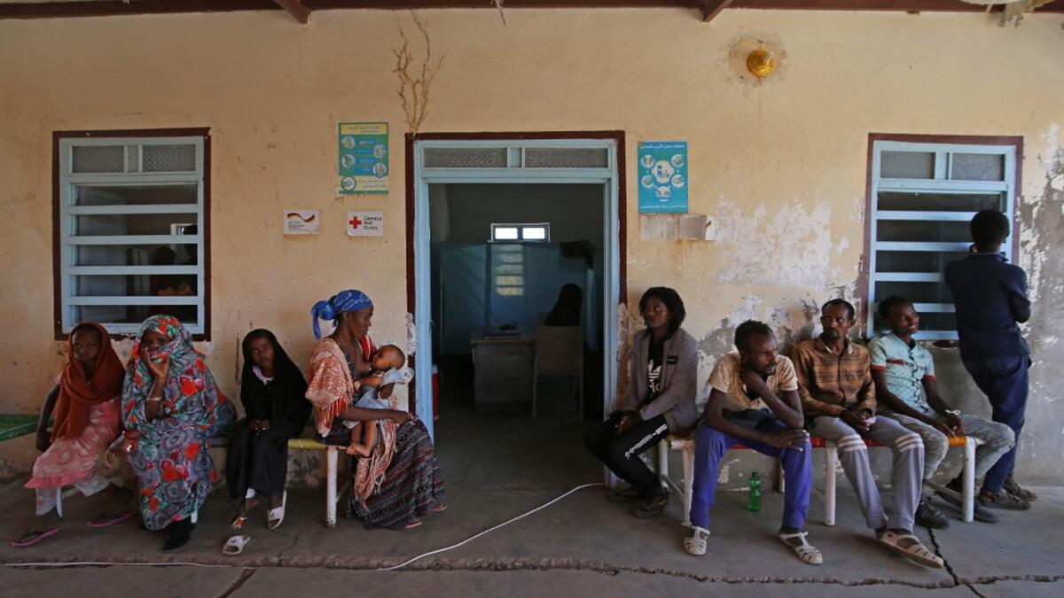 Ethiopian refugees who fled the fighting in the Tigray wait outside an aid facility in the Hamdayet area of Sudan's eastern Kassala state, on November 22, 2020. Ethiopia's northern Tigray region has been rocked by bloody fighting since November 4, when Ethiopia announced the launch of military operations there. The ongoing conflict is reported to have killed hundreds of people and forced thousands more to flee into neighbouring Sudan. ASHRAF SHAZLY / AFP