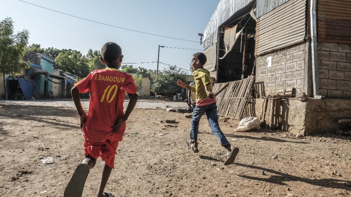 Children play next to the market in Humera, Ethiopia, on November 22, 2020. Prime Minister Abiy Ahmed, last year's Nobel Peace Prize winner, announced military operations in Tigray on November 4, 2020, saying they came in response to attacks on federal army camps by the party, the Tigray People's Liberation Front (TPLF). EDUARDO SOTERAS / AFP