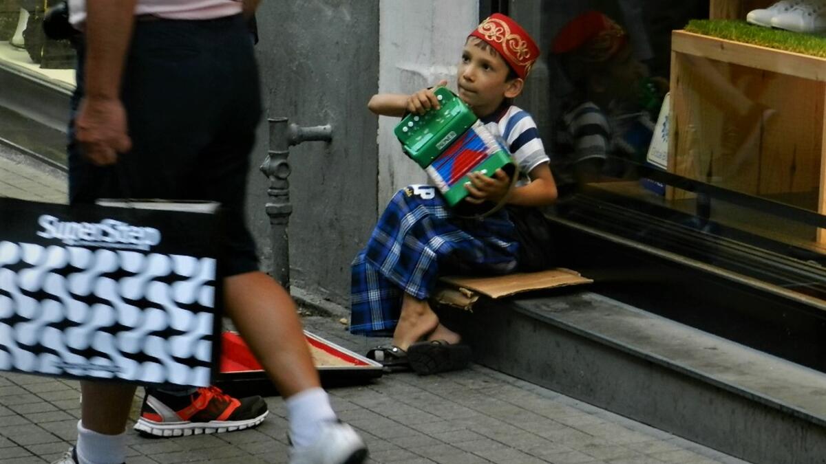A young street player collecting money in the center of Istanbul - Taksim Square/Photo by by Ewelina Lepionko
