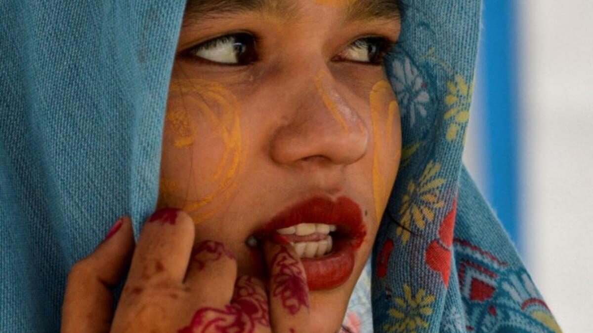 This photo taken on October 22, 2020 shows Rohingya refugee Amerah, 18, who said she has not seen her fiance -- who is a construction worker in Malaysia -- since she was six, at a temporary shelter in Lhokseumawe in Aceh province. Stay in a squalid refugee camp -- hopeless, starving, and made to feel a burden -- or leave, risking death, rape, human trafficking and months at sea to reach a husband you've never met. This is the bleak choice many Rohingya women, already scarred from fleeing persecution in Myan