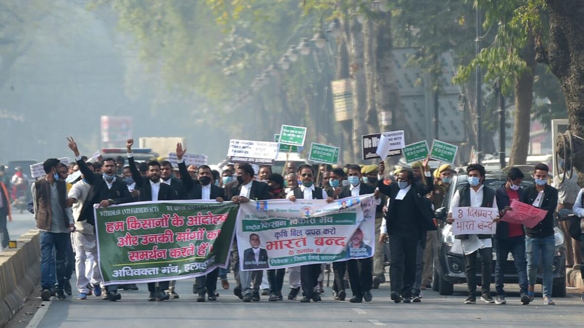 Members of All India lawyers union Acts march along a street during a protest in support of the nationwide general strike called by farmers against the recent agricultural reforms in Allahabad on December 8, 2020. SANJAY KANOJIA / AFP