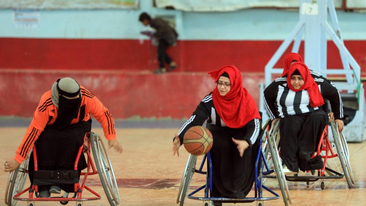 Disabled Yemeni women take part in a local wheelchair basketball championship in Yemen's capital Sanaa on December 8, 2020. In conflict-ridden Yemen, nine teams, including five-all women groups, competed in a local championship for the disabled in the capital Sanaa, which has been under rebel control since 2014. The players are competing to be embraced by society for their strengths rather than be viewed as a burden during the time of war. Mohammed HUWAIS / AFP