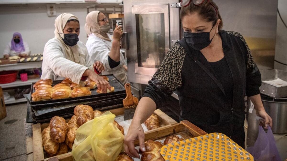 A Moroccan Jewish woman (R) fills bags with pastries to serve customers at the kosher bakery 'Madame Fhal' in the western Moroccan port city of Casablanca, on December 11, 2020 After the United Arab Emirates, Bahrain and Sudan, Morocco is the fourth Arab country since August to commit to establishing diplomatic relations with the Israel. In the 1950s and 60s, Jews from Iraq, Yemen and Morocco migrated to the Jewish state, where key posts were in the hands of Ashkenazi Jews, who hail from Europe. FADEL SENNA