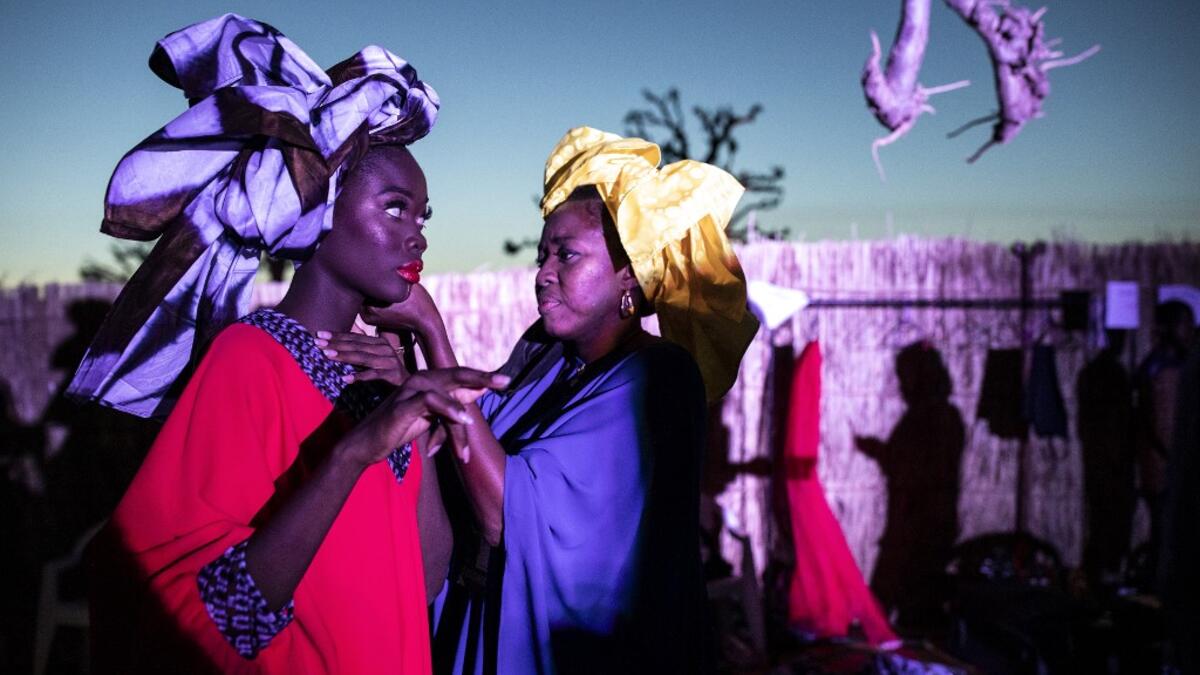 A fashion model gets the final touches done to her outfit during Dakar Fashion Week in Dakar on December 12, 2020. JOHN WESSELS / AFP