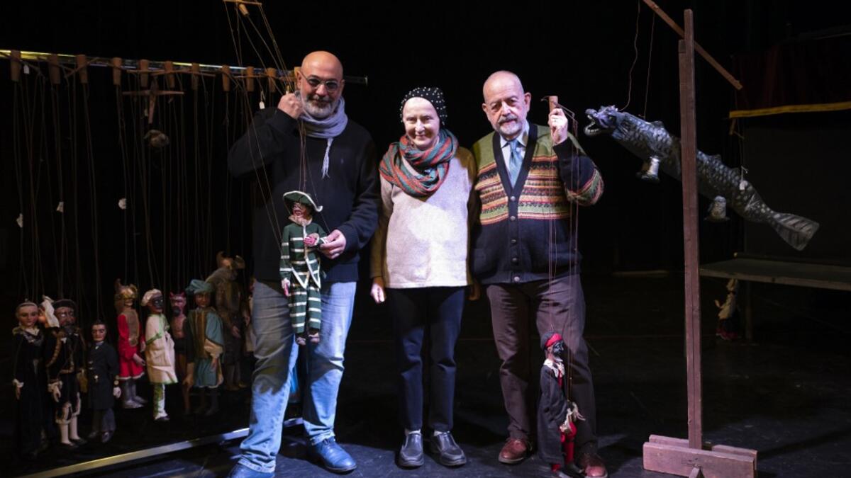 From left Marco, Maria Rosa and Augusto Grilli pose for a picture on November 30, 2020 at the " Alfa Theatre" in Turin. The Grilli family has a collection of more than 20,000 objects from around the world, everything from theatres, marionettes and glove puppets to shadow figures and silhouettes. A long-time dream of Grilli and his wife Mariarosa, 78, the museum is due to open in 2023 in Turin, financed both privately and publicly with the help of different institutions.  Marco Bertorello / AFP