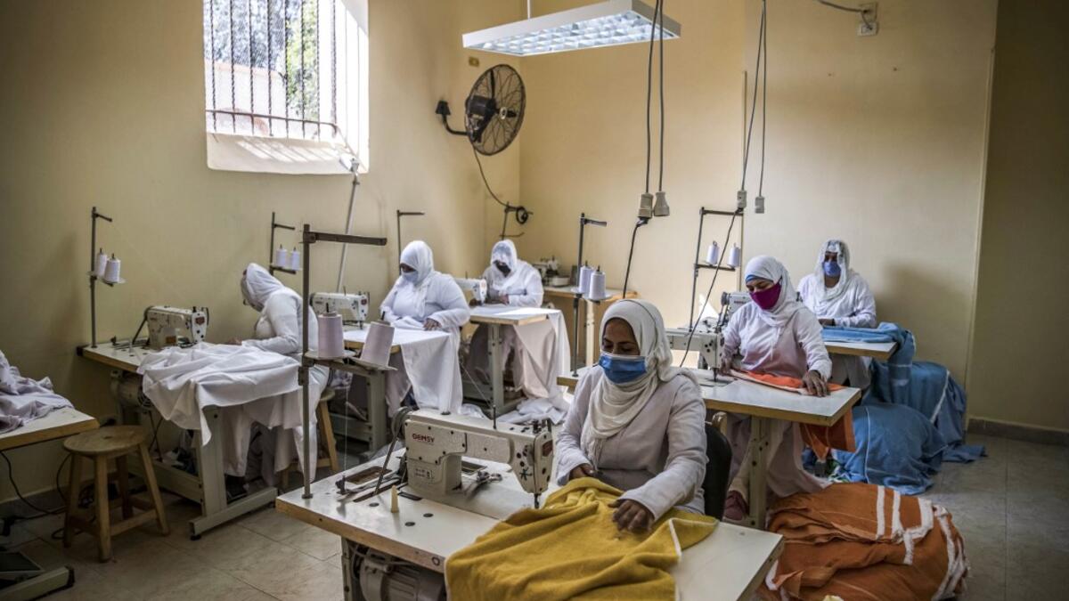 This picture taken during a government-guided tour on December 27, 2020 shows inmates operating sewing machines at a workshop at al-Qanatir women's prison, at the tip of the Nile delta in Qalyoubiya province, about 30 kilometres north of Egypt's capital. Khaled DESOUKI / AFP