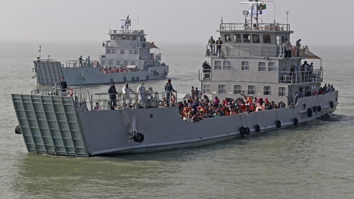 Rohingya refugees are seen on Bangladesh Navy ships as they are relocated to the controversial flood-prone island Bhashan Char in the Bay of Bengal, in Chittagong on December 29, 2020. REHMAN ASAD / AFP