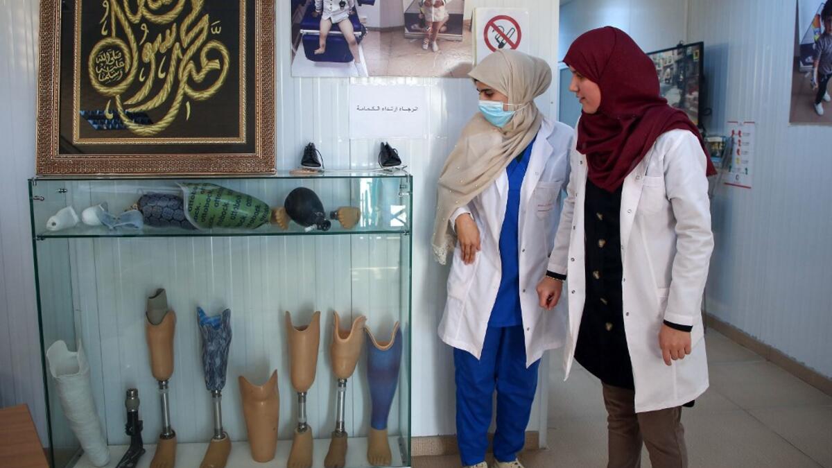 Members of staff work at the National Center for Artificial Limbs, in Libya's port city of Misrata, on December 17, 2020. With Libya's health sector left in tatters by its multiple conflicts since the 2011 revolution, war-wounded Libyans are often sent abroad for treatment, at the expense of the state. However, A national centre for prostheses, being established in Misrata, already has a patient waiting list of more than 3,000 amputees