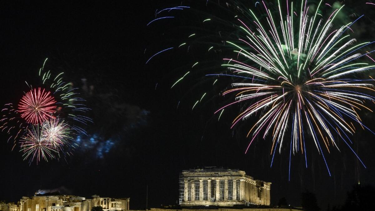 Fireworks explode over the ancient Acropolis in Athens during the new year's celebrations on December 31, 2020. LOUISA GOULIAMAKI / AFP