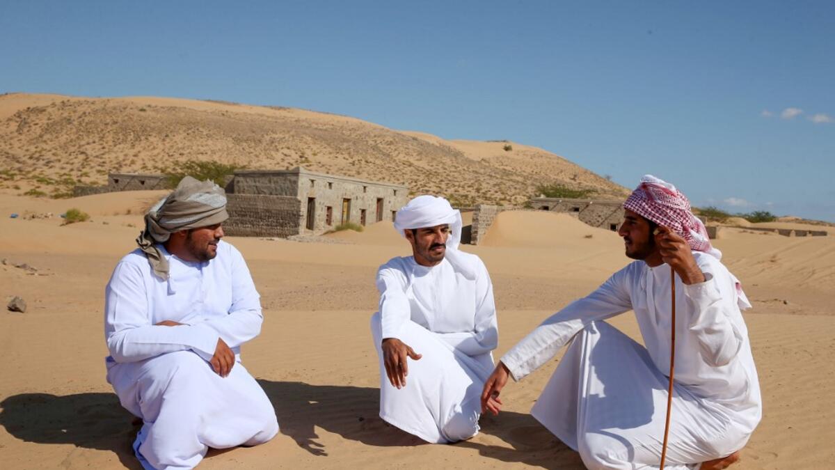 Former inhabitants of Wadi al-Murr, gather near abandoned houses in the Omani village, about 400 kms (250 miles) southwest of the capital Muscat, on December 31, 2020. MOHAMMED MAHJOUB / AFP