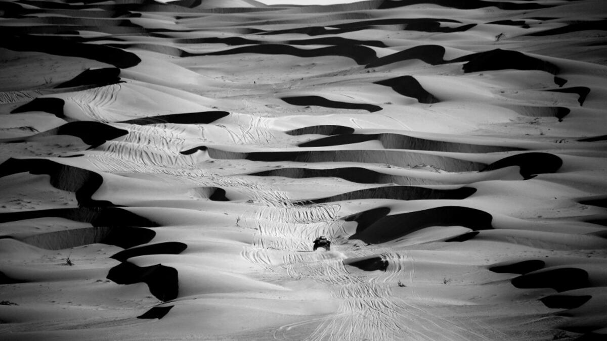 Mini's driver Stephane Peterhansel and his co-driver Edouard Boulanger of France compete during Stage 2 of the Dakar Rally 2021 between Bisha and Wadi Ad-Dawasir in Saudi Arabia, on January 4, 2021. FRANCK FIFE / AFP