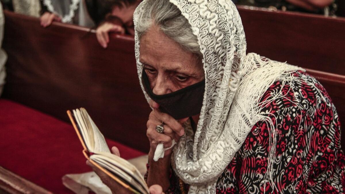 A Sudanese Copticwoman attends Christmas midnight mass at the capital Khartoum's Martyrs Church late on January 6, 2021, as the Orthodox Christian faith uses the old Julian calendar in which Christmas falls 13 days after the date in the more widespread Gregorian calendar.  Ebrahim HAMID / AFP