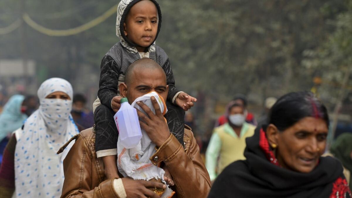 Hindu devotees arrive to take a holy dip at Sangam, the confluence of rivers Ganges, Yamuna and the mythical Saraswati, on the occasion of Makar Sankranti, a day considered to be of great religious significance in Hindu mythology, during the annual 'Magh Mela' festival in Allahabad on January 14, 2021. Sanjay KANOJIA / AFP