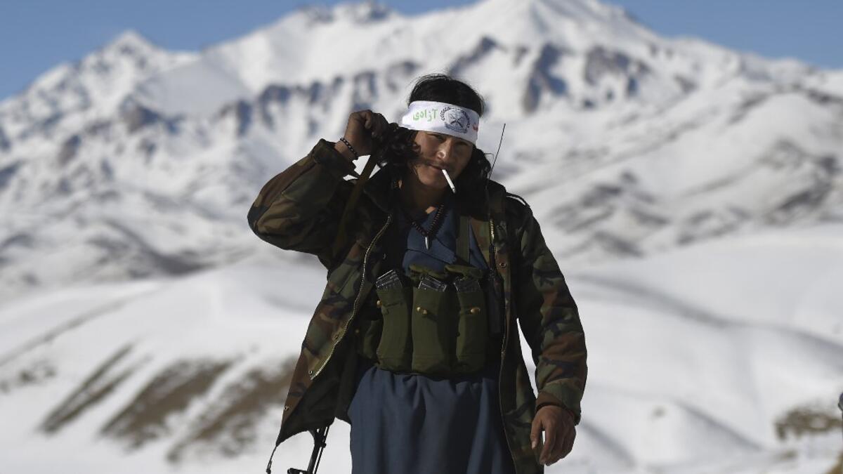 In this photo taken on January 9, 2021, a Hazara armed militia for the Resistance for Justice Movement, walks along the road during a patrol against Taliban insurgents at Hisa-e-Awali Behsud district of Maidan Wardak Province. Comprising roughly 10 to 20 percent of Afghanistan's 38-million population, Hazaras have long been persecuted for their largely Shiite faith by Sunni hardliners in a country wracked by deep ethnic divisions. WAKIL KOHSAR / AFP
