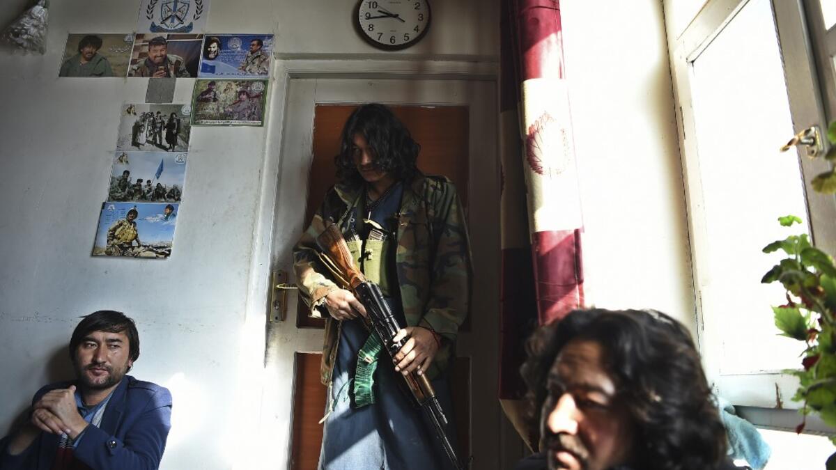 In this photo taken on January 9, 2021, Hazara armed militia for the Resistance for Justice Movement, stand inside their base ahead of a patrol against Taliban insurgents at Hisa-e-Awali Behsud district of Maidan Wardak Province. Comprising roughly 10 to 20 percent of Afghanistan's 38-million population, Hazaras have long been persecuted for their largely Shiite faith by Sunni hardliners in a country wracked by deep ethnic divisions. WAKIL KOHSAR / AFP