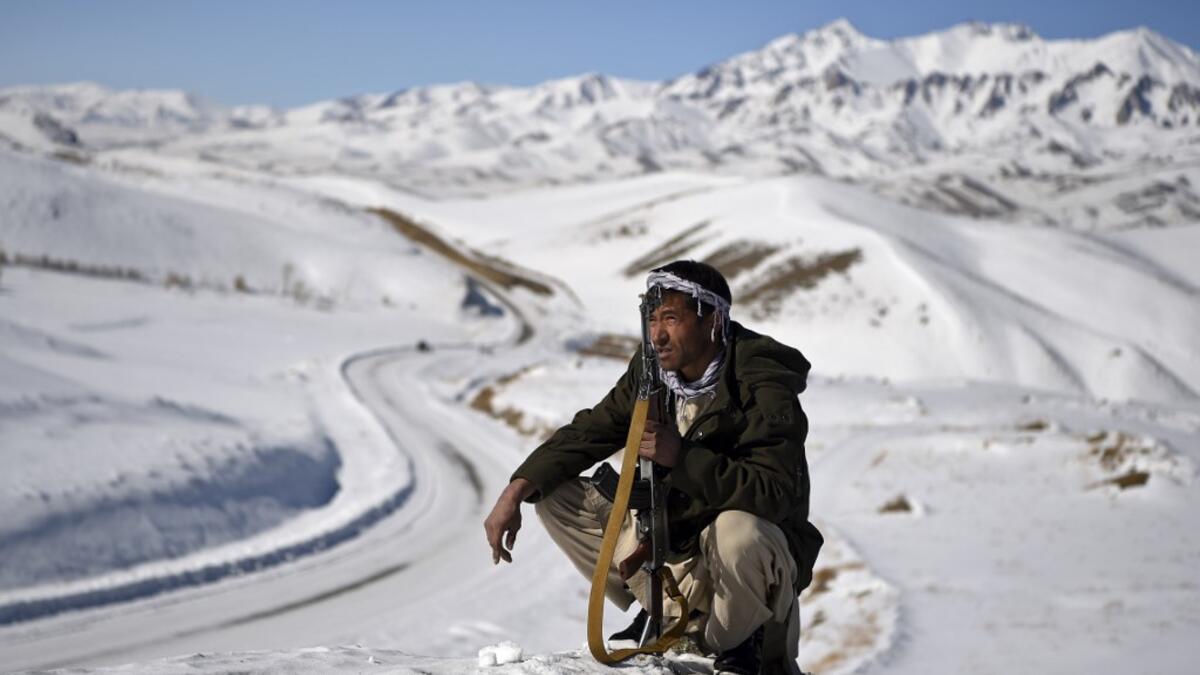 In this photo taken on January 9, 2021, a Hazara armed militia for the Resistance for Justice Movement, keeps watch during a patrol against Taliban insurgents at Hisa-e-Awali Behsud district of Maidan Wardak Province. Comprising roughly 10 to 20 percent of Afghanistan's 38-million population, Hazaras have long been persecuted for their largely Shiite faith by Sunni hardliners in a country wracked by deep ethnic divisions. WAKIL KOHSAR / AFP