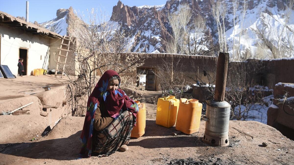 In this photo taken on January 6, 2021, a Hazara woman Jawahir Sedaqat, who lost two sons in an explosions on November 24 last year in the city of Bamiyan, sits in the courtyard of her house in the Somarah village on the outskirts of Bamiyan province. Comprising roughly 10 to 20 percent of Afghanistan's 38-million population, Hazaras have long been persecuted for their largely Shiite faith by Sunni hardliners in a country wracked by deep ethnic divisions. WAKIL KOHSAR / AFP