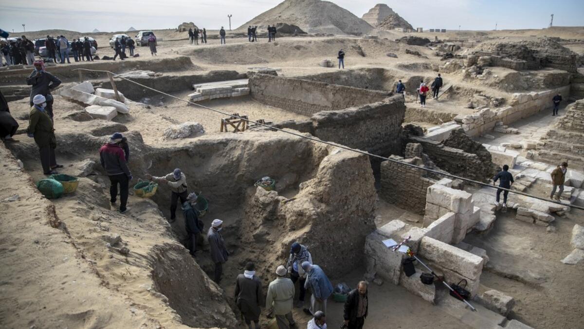 Workers excavate a site during the official announcement of the discovery by an Egyptian archaeological mission of a new trove of treasures at Egypt's Saqqara necropolis south of Cairo, on January 17, 2021. The discovery at the necropolis which lies 30kms south of the Egyptian capital, includes the funerary temple of Queen Naert, wife of King Teti, as well as burial shafts, coffins, and mummies dating back to nearly 3000 years ago during the New Kingdom. Khaled DESOUKI / AFP